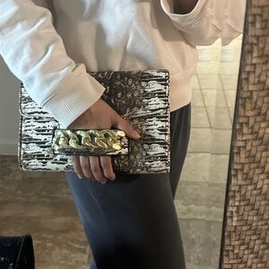 Faux snake skin clutch with strap for crossbody.